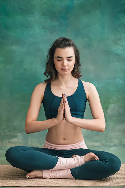 studio-shot-young-fit-woman-doing-yoga-exercises-green-space_155003-14216